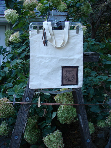 1998 PMU Patched Cotton Canvas Tote Bag Oak Leaf Natural One Size displayed on a wooden stand, showcasing tightly woven straps and oak leaf patches, embodying vintage creativity from Bluefishfinder.com.