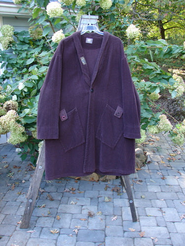 1999 Patched Chenille Angle Pocket Jacket Holiday Deep Burgundy Size 1 is displayed hanging on a rack, showcasing its oversized button closure, floppy pockets, and vintage patch detailing, reflecting Bluefishfinder.com's vintage clothing style.