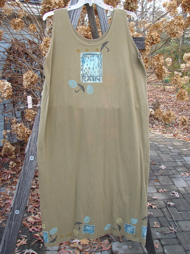 1992 Tank Dress Rain Rosemary OSFA: A dress on a clothesline, with a person wearing a tan shirt. Abundant elements theme paint featuring the rain and an old-time blue fish signature patch.