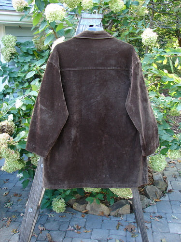 1999 Limited Edition Shed Jacket Unpainted Deepest Brown Size 1 displayed on a wooden stand, featuring oversized angular pockets and rubberized buttons, showcasing its plush, dense cotton texture and A-line shape.