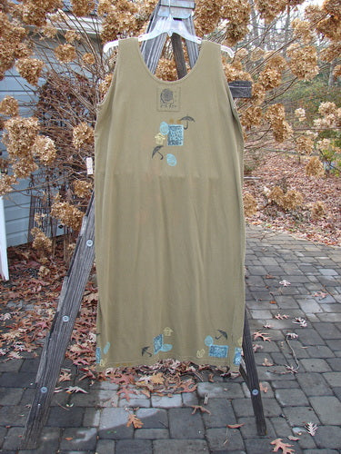 1992 Tank Dress Rain Rosemary OSFA: A dress on a rack, tan shirt on a swinger, and a close-up of a tree. Perfect condition, mid-weight cotton. Straight cut, scoop neckline, rain-themed paint, and Blue Fish signature patch. Own a piece of Blue Fish history!