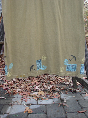 1992 Tank Dress Rain Rosemary OSFA: A cloth on a clothesline, tan fabric with blue and black designs. Outdoor ground.