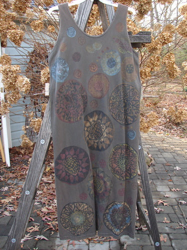 1992 Holiday Sleeveless Column Dress with a metallic pinwheel theme on a wooden stand.