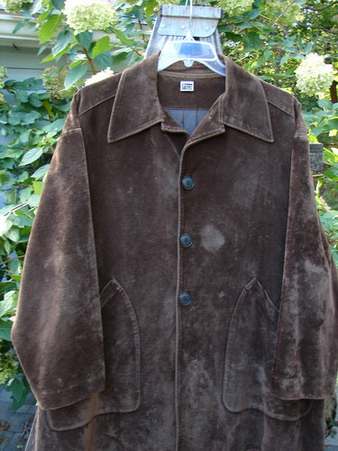 1999 Limited Edition Shed Jacket Unpainted Deepest Brown Size 1, displayed on a swing outdoors, featuring oversized pockets, rubberized buttons, and an A-line shape, embodying BlueFishFinder.com's vintage style.