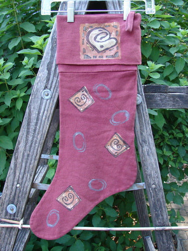 1995 Reprocessed Holiday Stocking Festive Hollyberry OSFA, featuring a spiral design and striking blue fish holiday paint, hangs on a ladder, showcasing its vintage charm and festive theme.