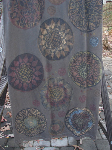 Image alt text: Sleeveless column dress with giant metallic pinwheel design, perfect for the holidays.