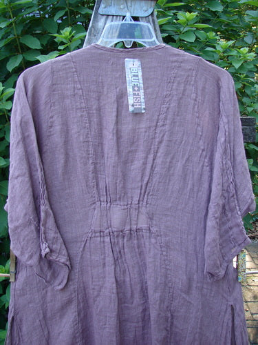 Barclay NWT Linen Venetian Dress Fern Field Tulsi Rose Size 0 on a swinger, showcasing its oval neckline, pinched three-quarter sleeves, and tall side vents for a flowy, versatile summer look.