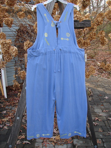 1993 Railroad Overall Jumper Abstract Tool Periwinkle Size 1: Blue overalls on a wooden fence with a yellow arrow.