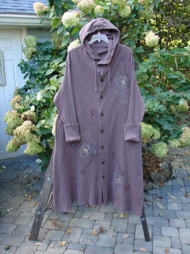 1995 PMU Thermal West Wind Coat Hooded Butterfly Currant Size 1 displayed on a wooden stand, showcasing its oversized hood, ribbed lower sleeves, deep side pockets, and distinctive butterfly-themed patches.