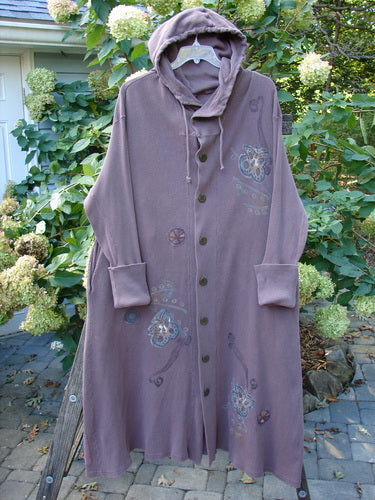 1995 PMU Thermal West Wind Coat Hooded Butterfly Currant Size 1 displayed on a rack, showcasing oversized metal buttons, deep side pockets, and contrasting fabric with ribbed lower sleeves and unique patches.