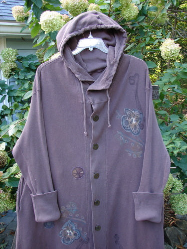 1995 PMU Thermal West Wind Coat Hooded Butterfly Currant Size 1 displayed on a mannequin, featuring an oversized hood, ribbed sleeves, deep pockets, and intricate butterfly and pinwheel patches.