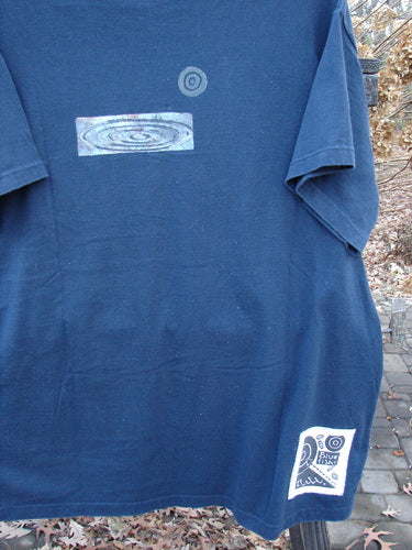 1998 Short Sleeved Tee Arrow Game Crew Blue Size 2: A blue t-shirt with a logo and design on it. Made from organic cotton, it features drop shoulders, a ribbed neckline, and a Blue Fish patch.