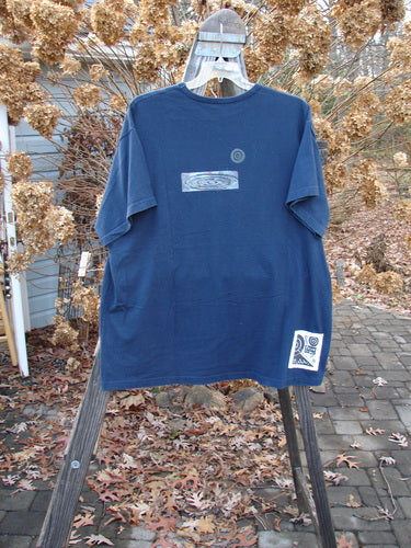 1998 Short Sleeved Tee Arrow Game Crew Blue Size 2: A blue t-shirt with arrow game theme paint, drop shoulders, and a ribbed neckline. Made from organic cotton.