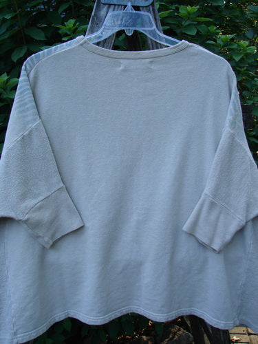 Barclay Hemp Cotton Banded Sleeve Colors Sweatshirt Elements Cloud OSFA displayed on a clothes rack, showcasing its wide boxy shape, banded lower sleeves, and contrasting textured hemp side panels.