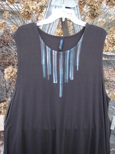 A Barclay Rayon Lycra A Line Tunic in Mortar, featuring a black shirt with a design on it. The tunic has a sweet rounded neckline accented by a painted necklace, deeper arm openings, and a widening lower shape. It has a superior bounce and sway, made from a forever forgiving fabric. The measurements are as follows: Bust 50, Waist 50, Hips 56, Sweep 66, and Length 33 inches.