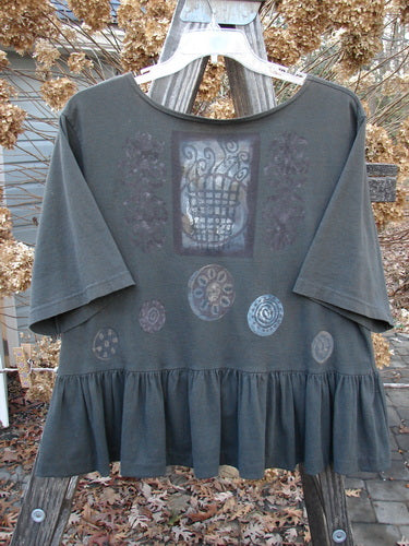 1992 Holiday Short Sleeved Peplum Top Black Sand Size 1: A shirt on a swinger with a grey design, drop shoulders, and a peplum lower.