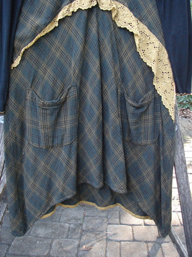 Barclay Rayon Linen Ruffle Pocket Dress in brown plaid, featuring a hi-low hemline, ribbed sleeves, lace accents, and a lightweight hoodie, embodies Bluefishfinder.com's vintage charm and creative expression.