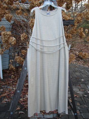 1998 Linen Knit Wrap Dress Unpainted Natural Size 2: A dress on a clothes rack, with a white skirt and belt, draped with a white cloth on a ladder.