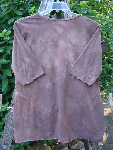 Barclay Cotton Lycra Three Quarter Sleeved A Line Tee Roots Mottled Clay Size 1 displayed on a clothes rack, showcasing its unique A-line shape, rounded neckline, and sweet curly edgings.