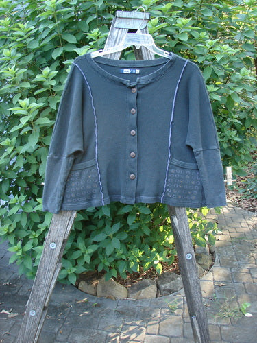 Barclay Thermal Exterior Stitch Two Pocket Jacket Geos Army Size 0 displayed on a wooden ladder, showcasing its long narrowing sleeves, double drop exterior painted pockets, and vertical stitch details.