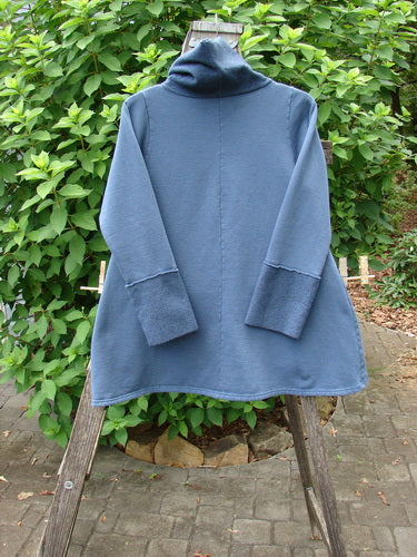 Barclay Fleece Mock Collar Pullover Sweatshirt Metallic Wheat Deep Tealen Size 0 features a cowl collar and wide sleeves, shown on a wooden stand emphasizing its artistic design and cozy fleece texture.
