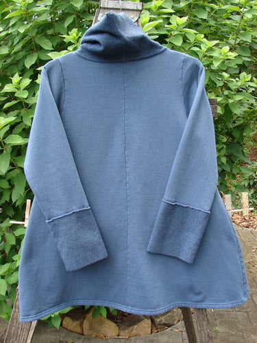 Barclay Fleece Mock Collar Pullover Sweatshirt Metallic Wheat Deep Tealen Size 0, featuring long sleeves, a cowl collar, and artistic metallic detailing, showcased on a clothes rack.