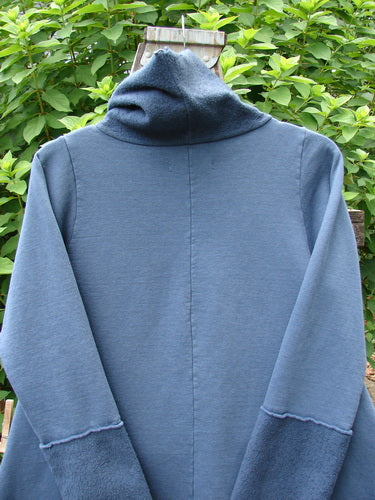 Barclay Fleece Mock Collar Pullover Sweatshirt Metallic Wheat Deep Tealen Size 0 displayed on a wooden pole, showcasing its A-line shape, Celtic Moss cowl collar, and long wide sleeves.