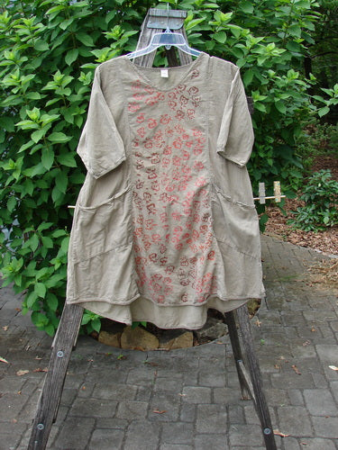 Barclay Batiste Bliss Dress Fallen Petal Stonetail Size 0 displayed on a rack, showcasing its short sleeves, drawcord back, and two exterior flop pockets, embodying BlueFishFinder's vintage-inspired individuality.