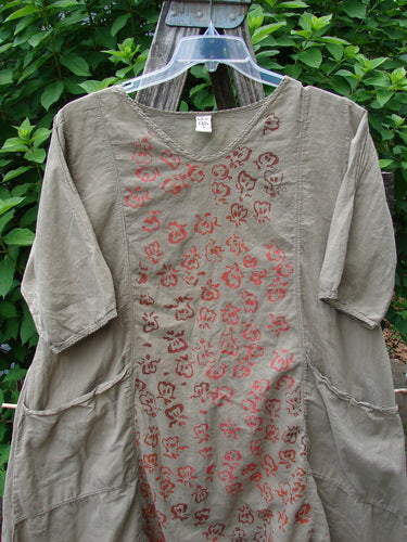 Barclay Batiste Bliss Dress Fallen Petal Stonetail Size 0 on hanger; features soft rounded neckline, short sleeves, central art section, exterior pockets, drawcord back, showcasing artistic floral pattern on organic cotton fabric.