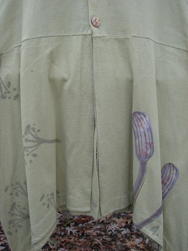 1998 Botanicals Aster Vest: Close-up of a skirt-like cloth with unique vents and wavy shell-like buttons. Perfect condition, made of organic cotton.