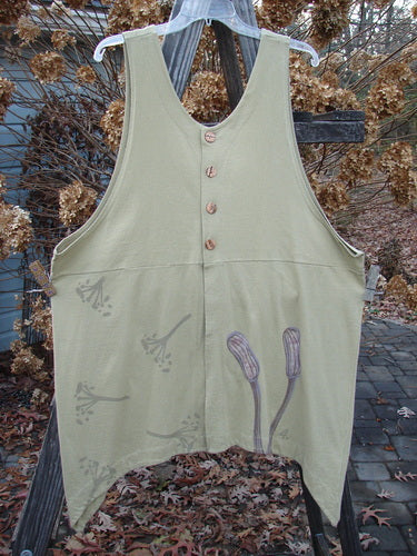 1998 Botanicals Aster Vest Long Stem Seed Size 2: A white shirt with buttons on a wooden fence. A close-up of a vest with unique front and rear vents accented by wavy shell-like buttons. Perfect for layering with other Botanicals from this collection.