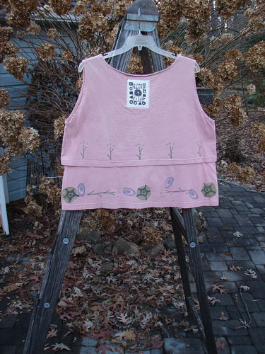 1993 Parallel Top Twig Ash Pink OSFA: A pink shirt on a wooden easel, featuring a crop A-line cut, wide rounded neckline, and double-layered bodice. Perfect condition.