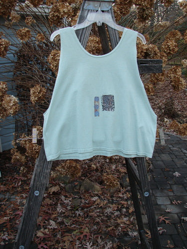 1992 Workout Tank Elements Cucumber OSFA: A white tank top on a wooden ladder. Perfect for hot summer days. Slightly smaller size with deep arm openings and a scooped neckline. Features the signature Blue Fish Patch.