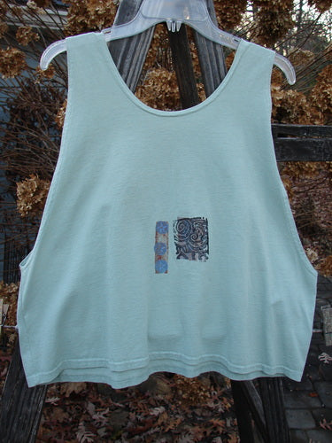 1992 Workout Tank Elements Cucumber OSFA: Light blue tank top with a patch on it, perfect for hot summer days. Slightly smaller size, deep arm openings, and a scooped neckline. Made from mid-weight cotton.