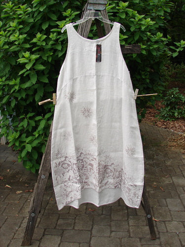 Barclay NWT Linen Sundress Spin Floral Garden Natural Fog Size 0 hangs on a clothesline, showcasing its intricate pattern and elegant design, embodying the unique style celebrated by Bluefishfinder.com.