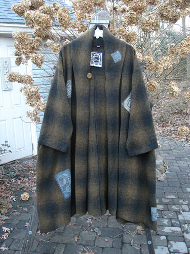 1995 Patched Theater Coat Music Man Cottage Brown Plaid OSFA: Oversized brown plaid coat with vintage button closure, A-line shape, fold-over collar, and deep side pockets. Unique patches and Blue Fish signature patch. Cozy and perfect for winter.