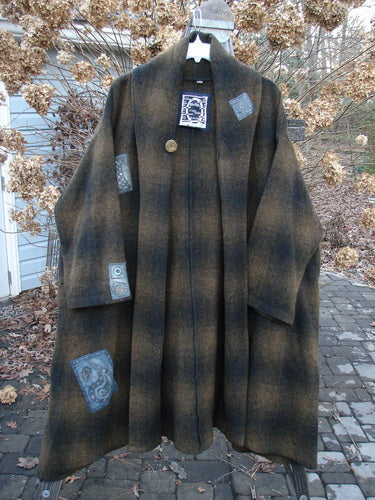 1995 Patched Theater Coat Music Man Cottage Brown Plaid OSFA: A cozy vintage coat with an oversized button closure, A-line shape, and deep side pockets. Features a double-layered fold-over collar and unique patches.