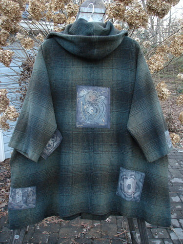 1995 Patched Hooded Autumn Jacket in Cottage Green Plaid. A cozy, oversized coat with vintage buttons, a lined hood, and deep pockets.