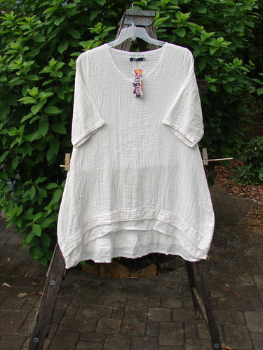 Barclay NWT Gauze Hi Low Batiste Flutter Dress in Unpainted Jasmine Dew, Size 0, displayed outdoors featuring a distinctive pattern and flutter sleeves, reflecting BlueFishFinder's vintage-inspired, creative fashion ethos.