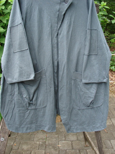 Barclay NWT Reprocessed Patched Hooded Button Jacket in Unpainted Grey Storm Size 0 showcased hanging outdoors, highlighting its distinctive patchwork and hood design, reflecting Bluefishfinder.com's vintage aesthetic.