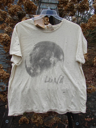 Magnolia Pearl NWT Short Sleeved Boyfriend Tee Luna Moonlight OSFA: A white shirt with a moon, made from light cotton jersey. Features include raw edges, an A-line lower hem, and a diagonal waist to hem seam.