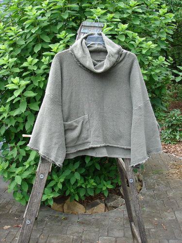 Barclay Sherpa Patched Wide Cowl Pocket Pullover Unpainted Sea Moss OSFA displayed on a wooden ladder, showcasing its unique wide cowl neckline and textured fabric, embodying Bluefishfinder.com's vintage aesthetic.
