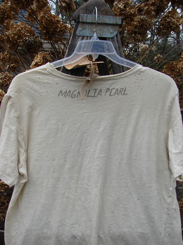 Magnolia Pearl NWT Short Sleeved Boyfriend Tee Luna Moonlight OSFA: A soft, lightweight white t-shirt on a swinger with raw edges and a diagonal waist to hem seam.