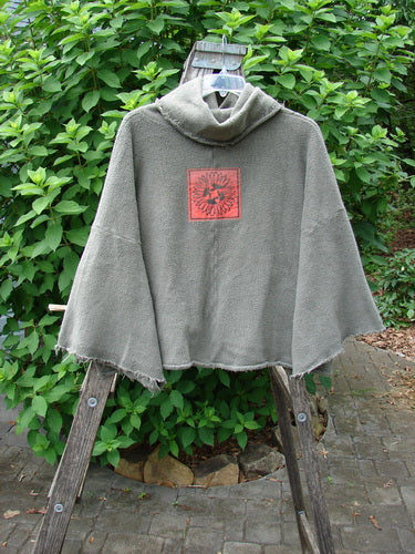 Barclay Sherpa Patched Wide Cowl Pocket Pullover in Unpainted Sea Moss, featuring a cozy grey design with a distinctive red logo, perfect for expressing individuality and style.