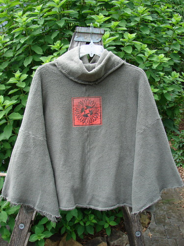 Barclay Sherpa Patched Wide Cowl Pocket Pullover Unpainted Sea Moss OSFA—a stylish poncho with a distinctive red square detail, perfect for expressing individuality through vintage-inspired fashion.