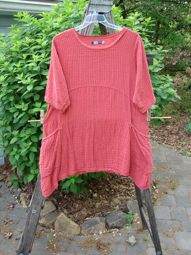 Barclay Gauze Two Pocket Urchin Dress in Geranium Stripe features a unique flutter neckline, three-quarter sleeves, and lower wrap drop pockets, embodying vintage Blue Fish's creative spirit.