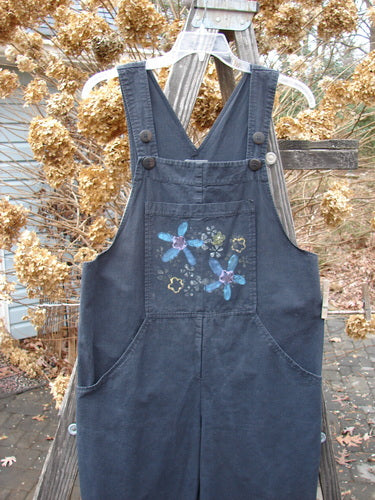 2000 Parachute Overall Jumper with floral design, featuring oversized front bib pocket, adjustable shoulder straps, and wide swingy lowers. Size 0.