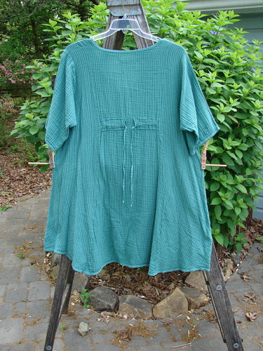 Barclay Gauze Key Pocket Everyday Dress in Unpainted Spearmint Stripe, featuring a unique keyhole neckline, three-quarter sleeves, triangular drop pockets, and drawcord back, highlighting its creative and vintage-inspired design.