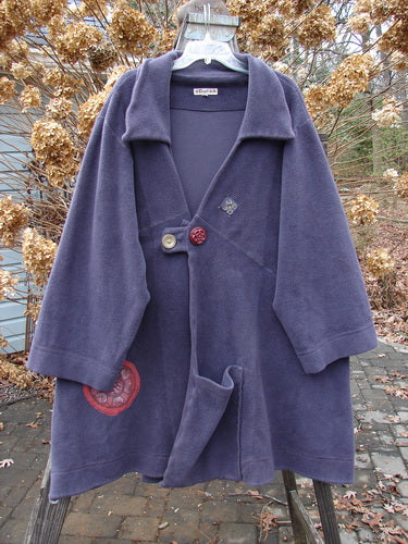 Barclay Celtic Moss Patched Highlander Coat: A purple coat with oversized vintage buttons, diagonal seams, and significant patches throughout.