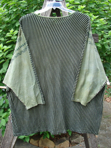 Barclay Modernist High Low Top Continuous Path Black Green Stripe OSFA, displayed on a clothes rack, showcases its unique pattern with varying front and back lengths, embodying Bluefishfinder.com's vintage-inspired creativity.